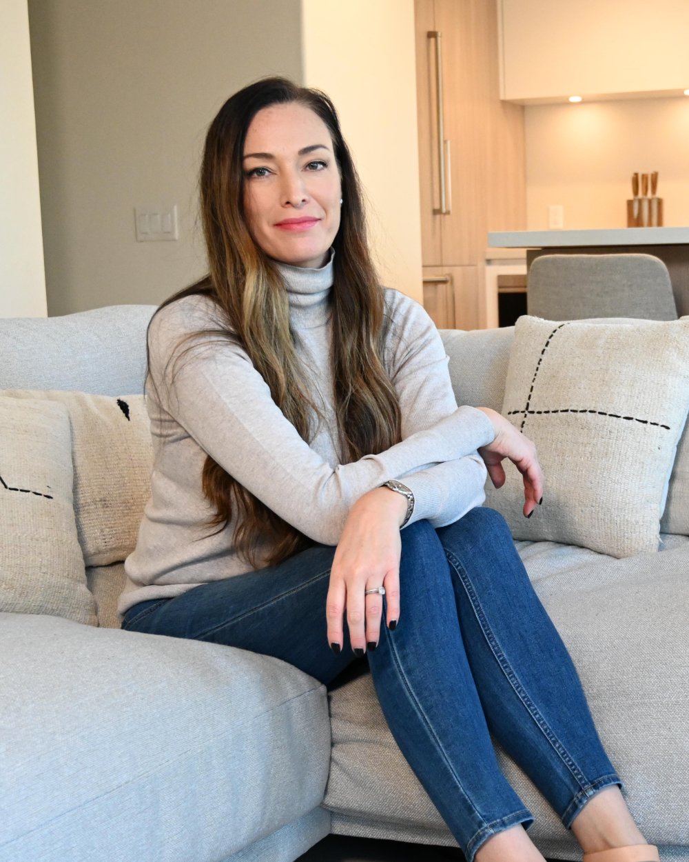 Aja sitting on a sofa at home